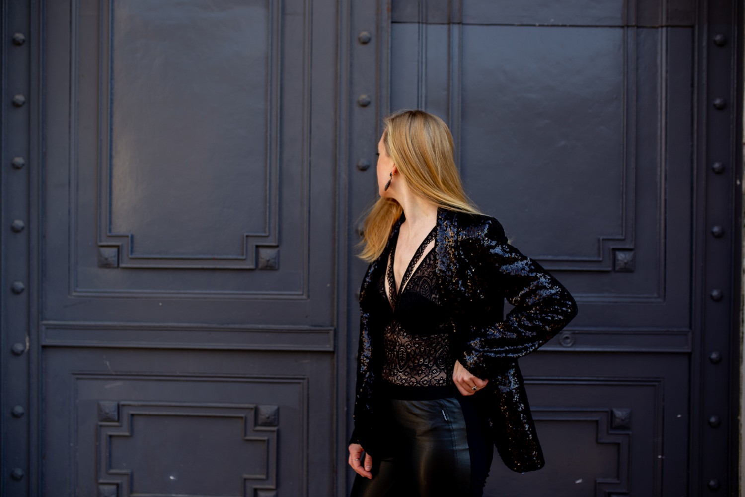 A black lace body with leather leggings and sequin jacket